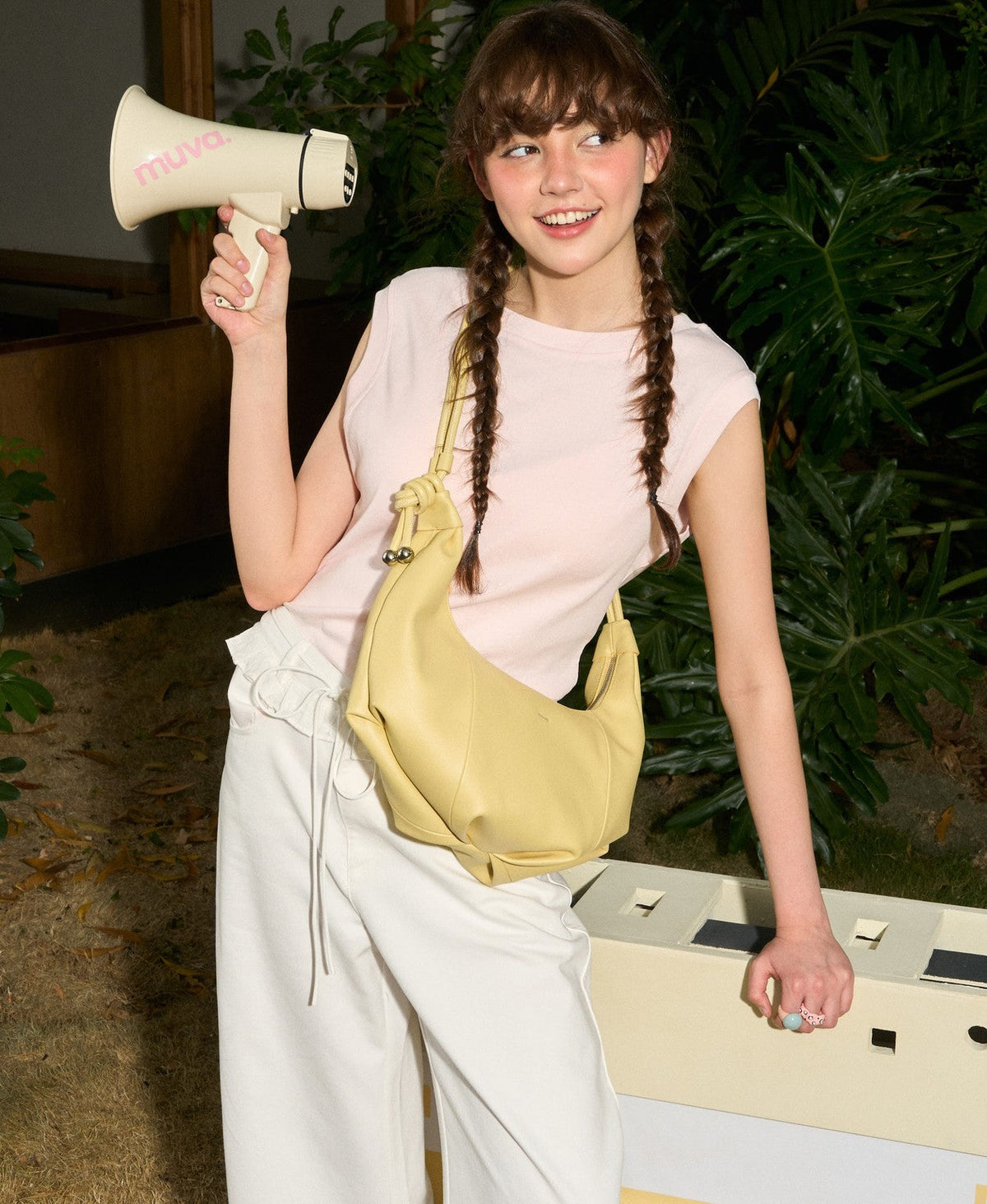 Model carrying the Jingle Croissant Bag in Creamy Yellow