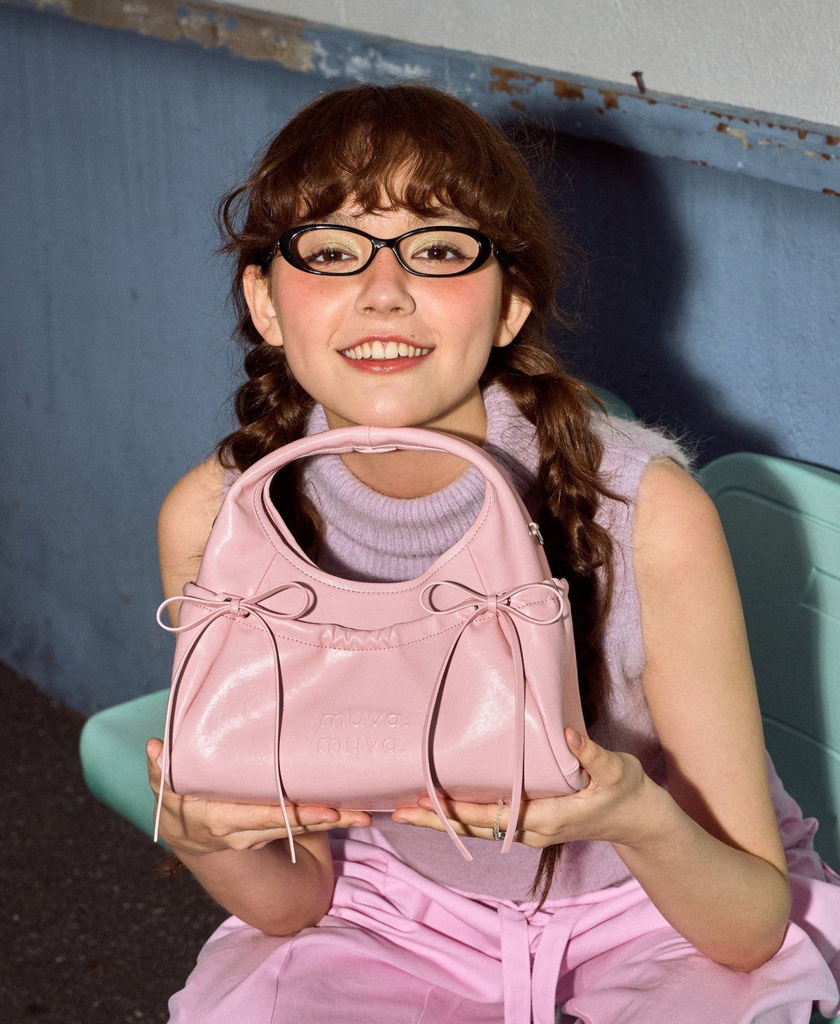 Model carrying the Sweet Cool Bow Bag in Cherry Blossom Pink