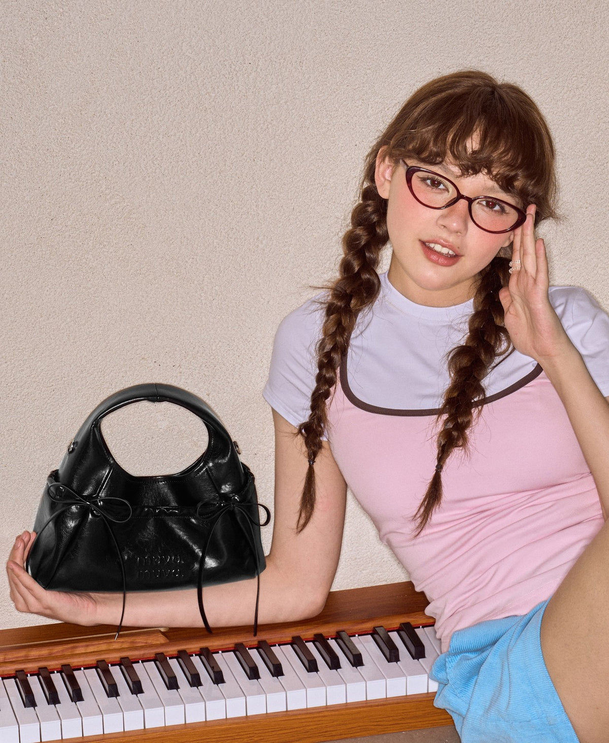 Model carrying the Sweet Cool Bow Bag in Black