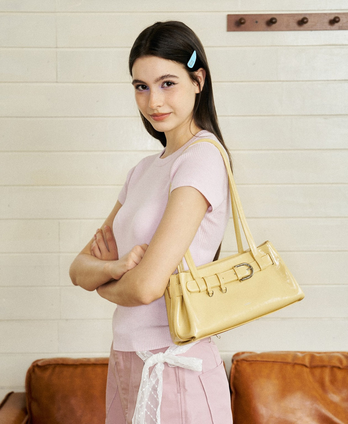 Model carrying the Sweet Cool Buckle Bag in Creamy Yellow