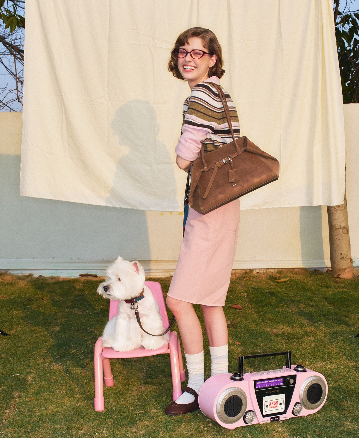 Model carrying the Tab Strap Fold-Over Shoulder Bag · Microsuede in Latte Brown