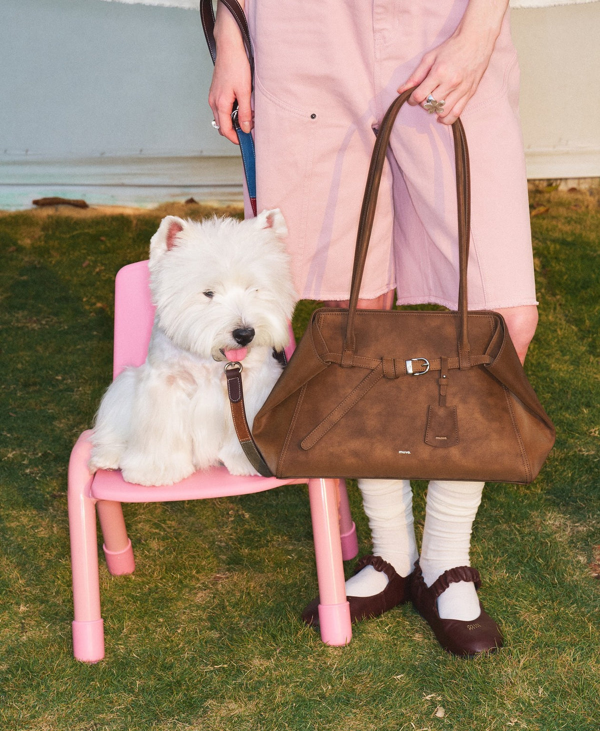 Model carrying the Tab Strap Fold-Over Shoulder Bag · Microsuede in Latte Brown