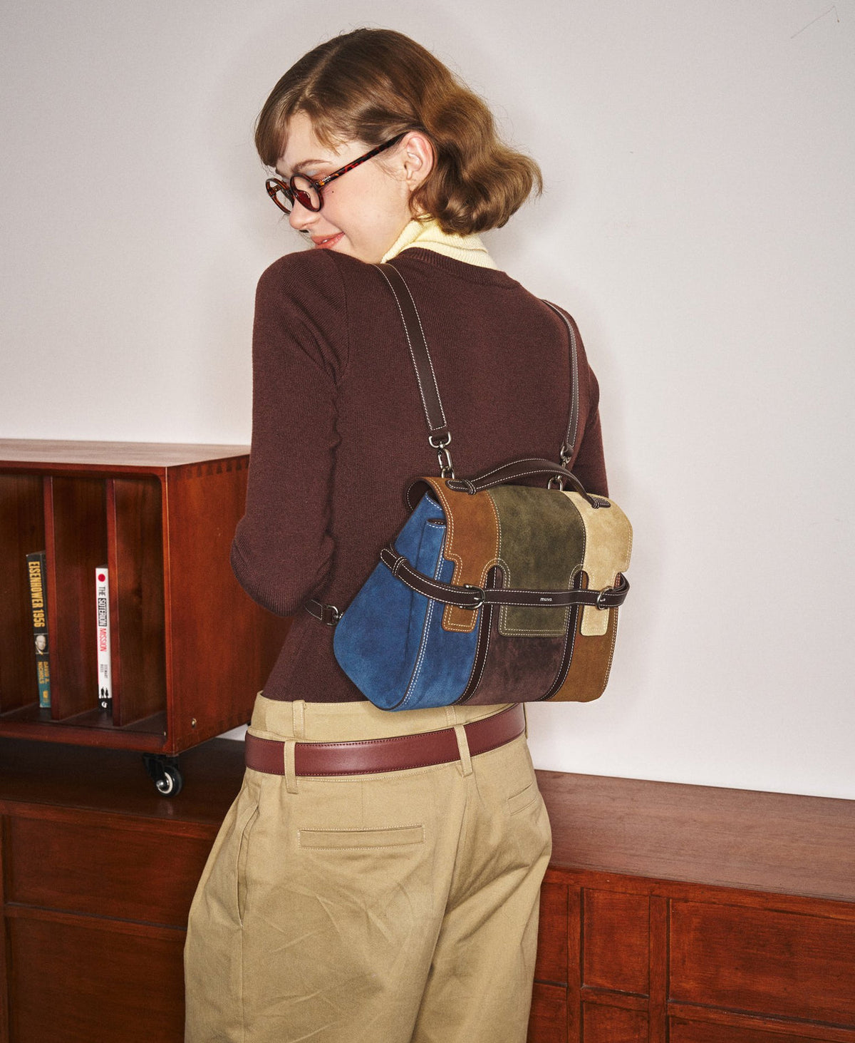 Model carrying the Hopscotch Tales Backpack in Patchwork