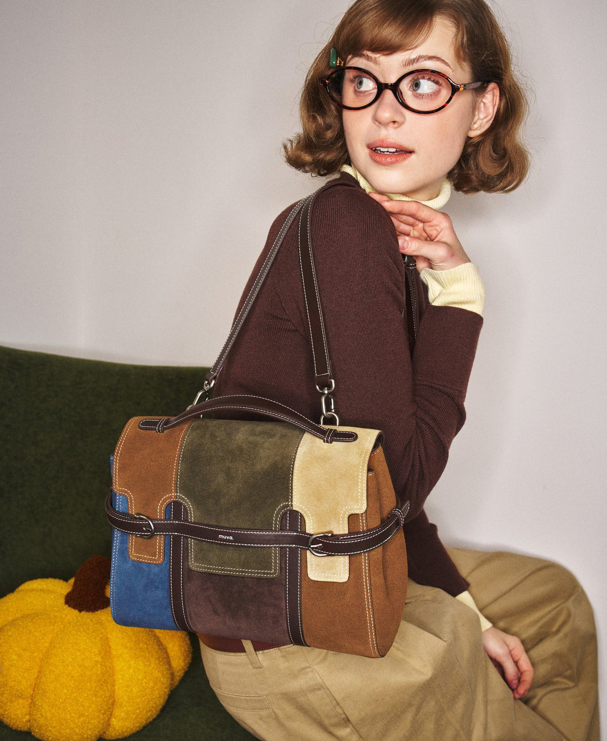 Model carrying the Hopscotch Tales Backpack in Patchwork
