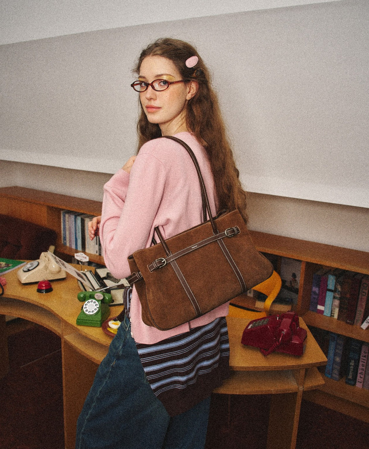 Model carrying the Hopscotch Tales Garden Tote Bag · Suede in Caramel Brown