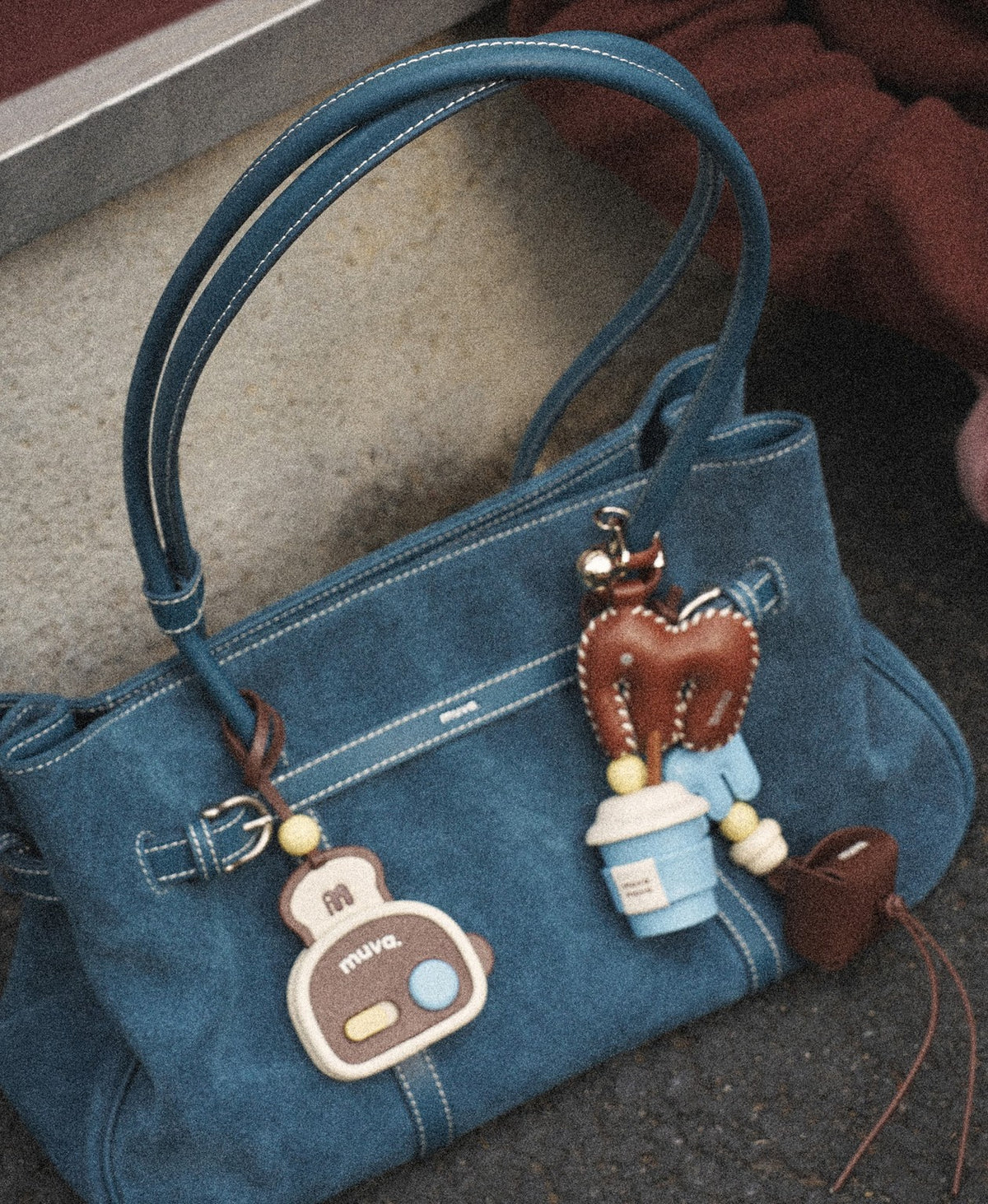 Model carrying the Hopscotch Tales Garden Tote Bag · Suede in Denim Blue