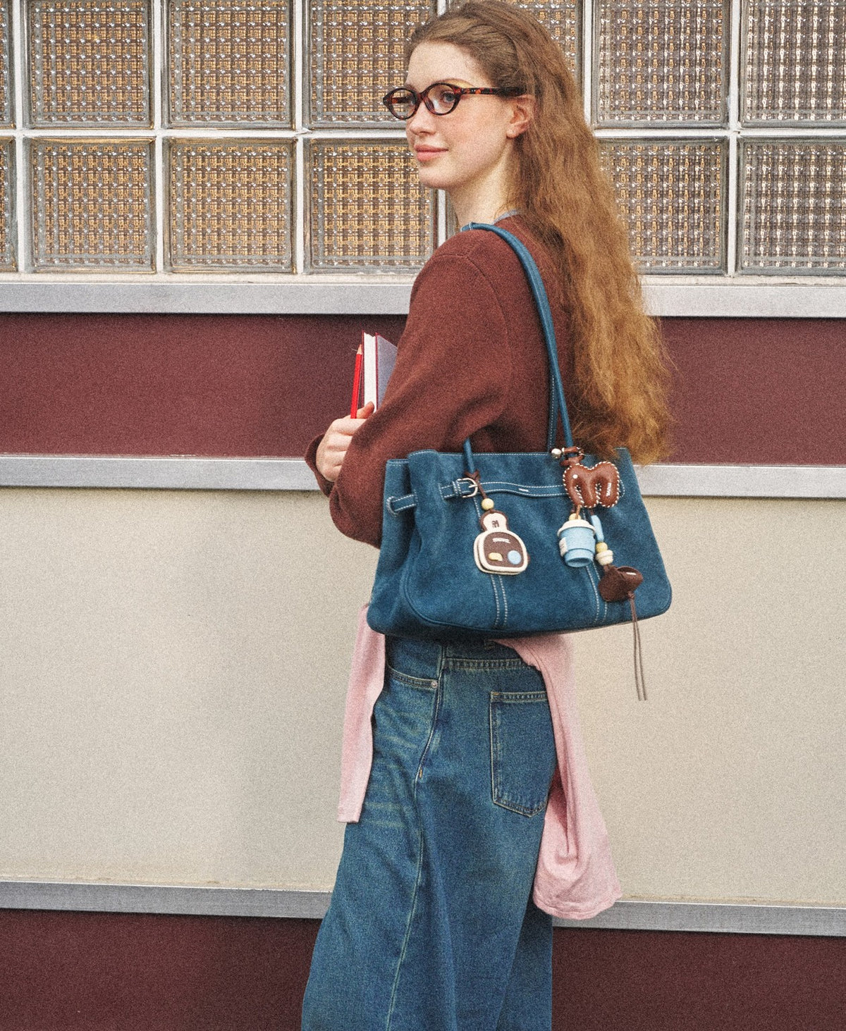 Model carrying the Hopscotch Tales Garden Tote Bag · Suede in Denim Blue