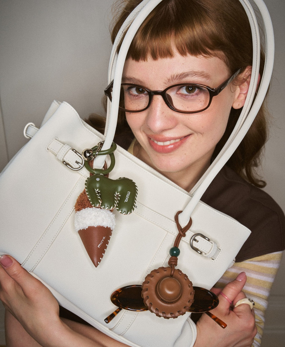 Model carrying the Hopscotch Tales Garden Tote Bag in Milkshake White