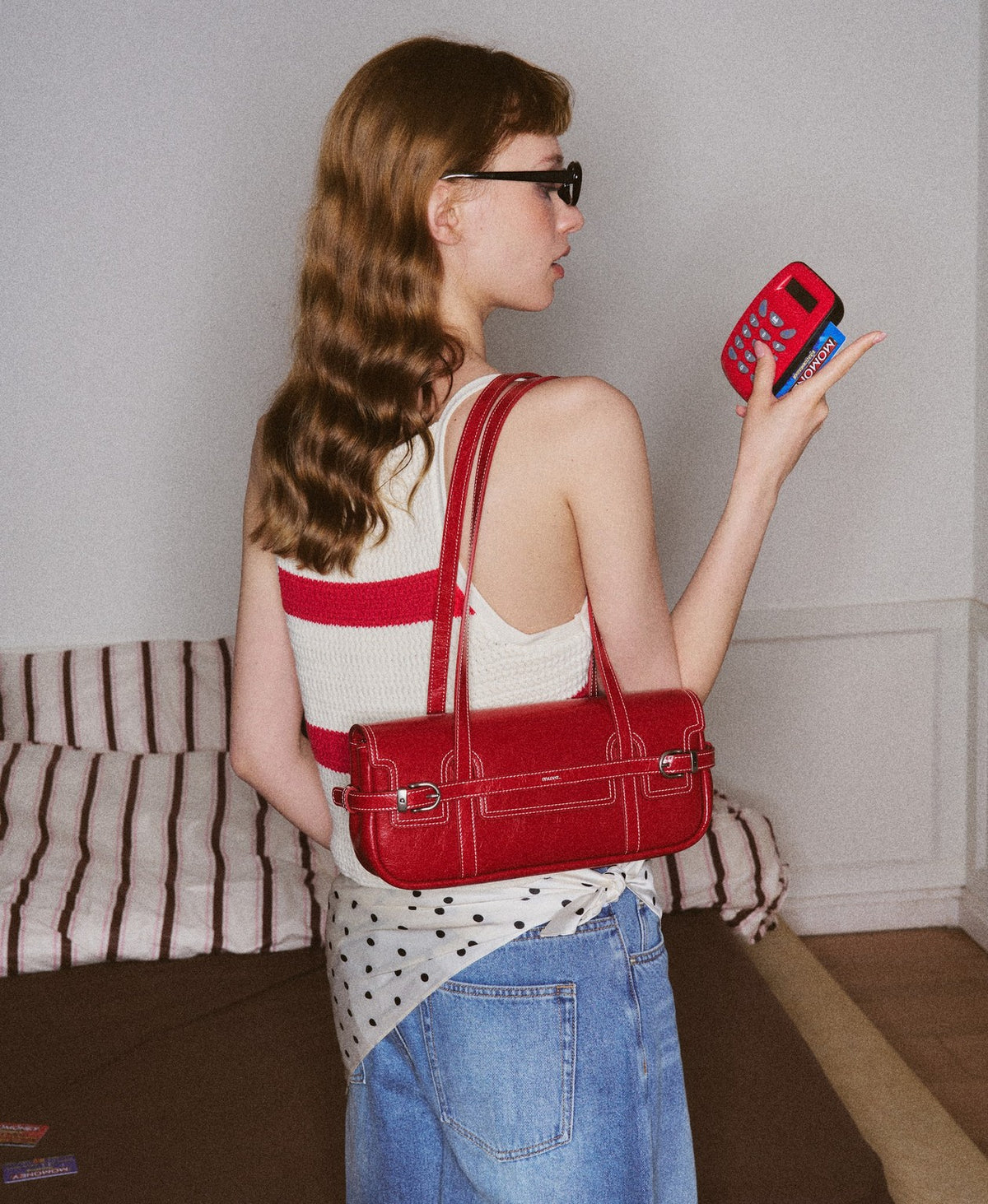 Model carrying the Hopscotch Tales Hopscotch Baguette Bag in Red