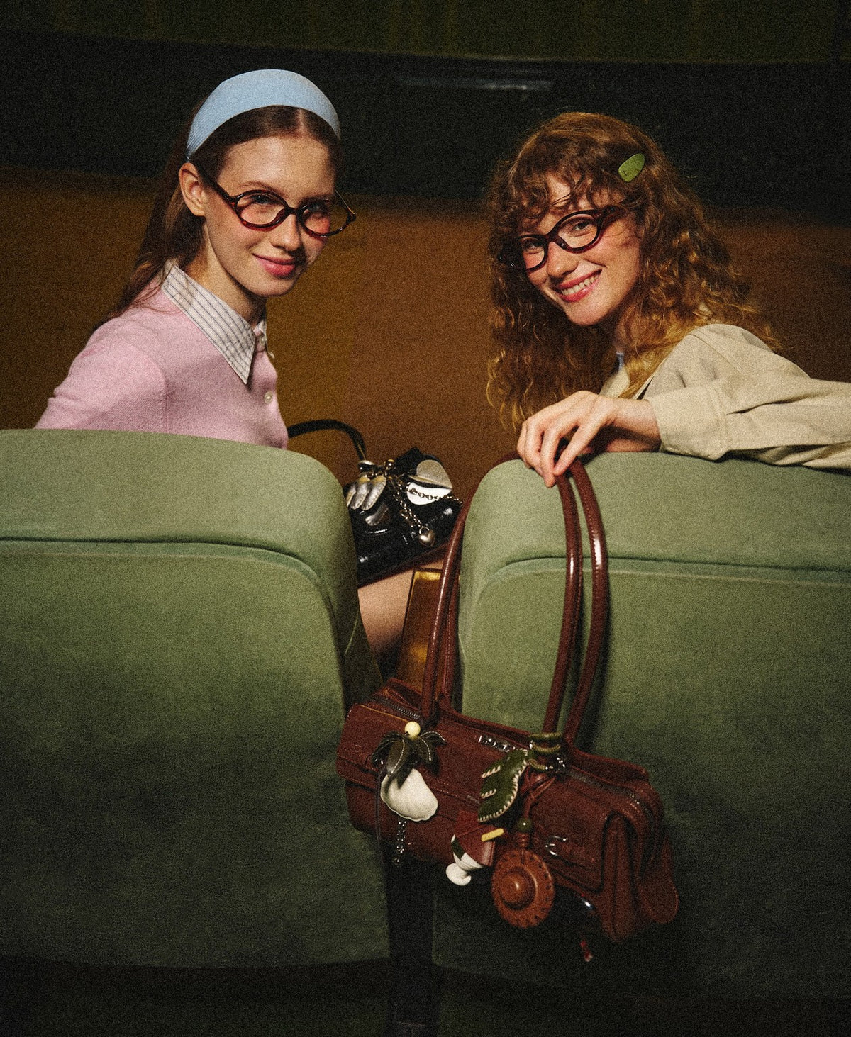 Model carrying the Hopscotch Tales Garden Shoulder Bag · Gloss in Caramel Brown