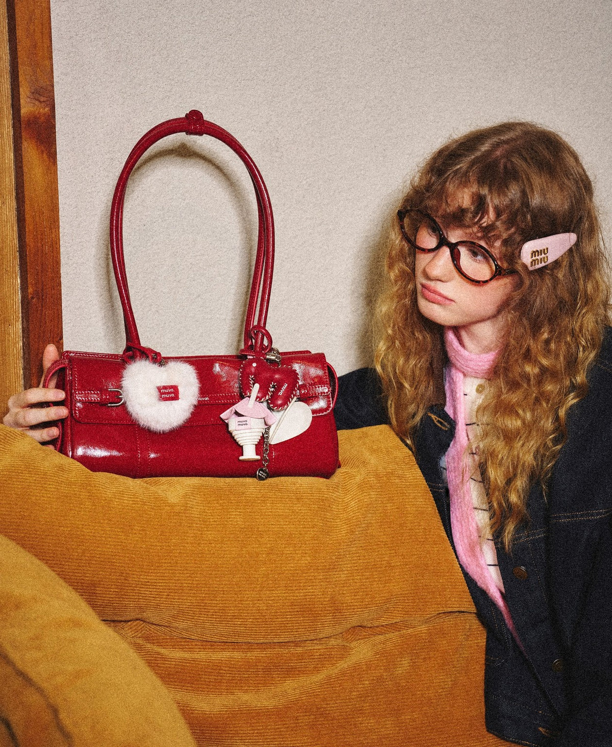 Model carrying the Hopscotch Tales Garden Shoulder Bag · Gloss in Red