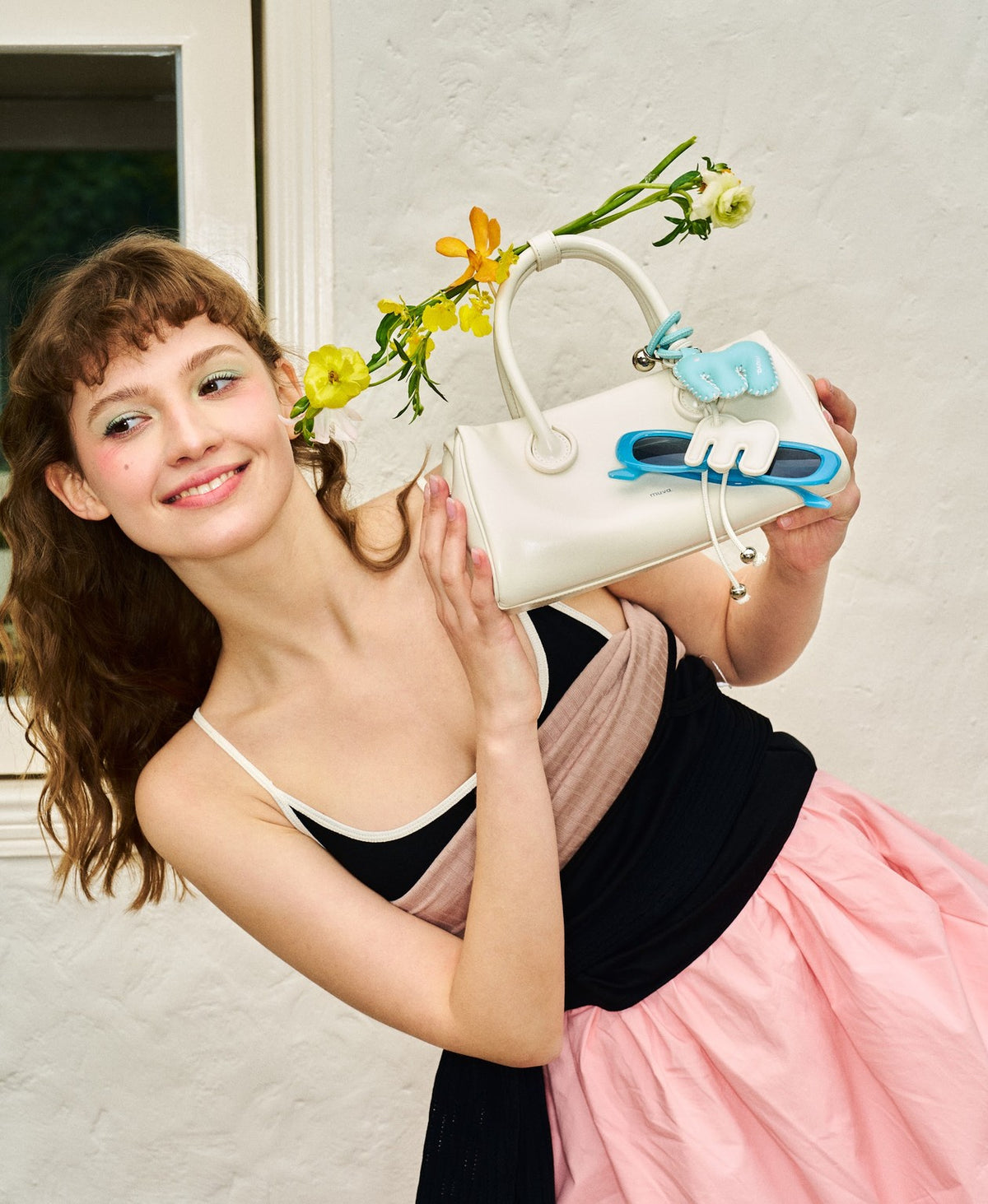 Model carrying the Bakery Pretzel Bag in Milkshake White