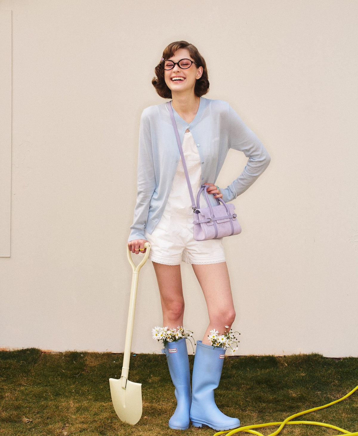 Model carrying the Hopscotch Tales Hopscotch Bag · Pastel Suede in Purple Yam