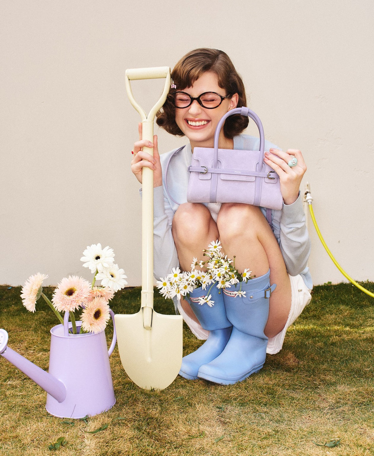 Model carrying the Hopscotch Tales Hopscotch Bag · Pastel Suede in Purple Yam