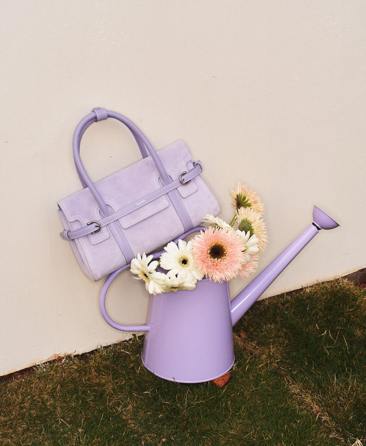 Model carrying the Hopscotch Tales Hopscotch Bag · Pastel Suede in Purple Yam