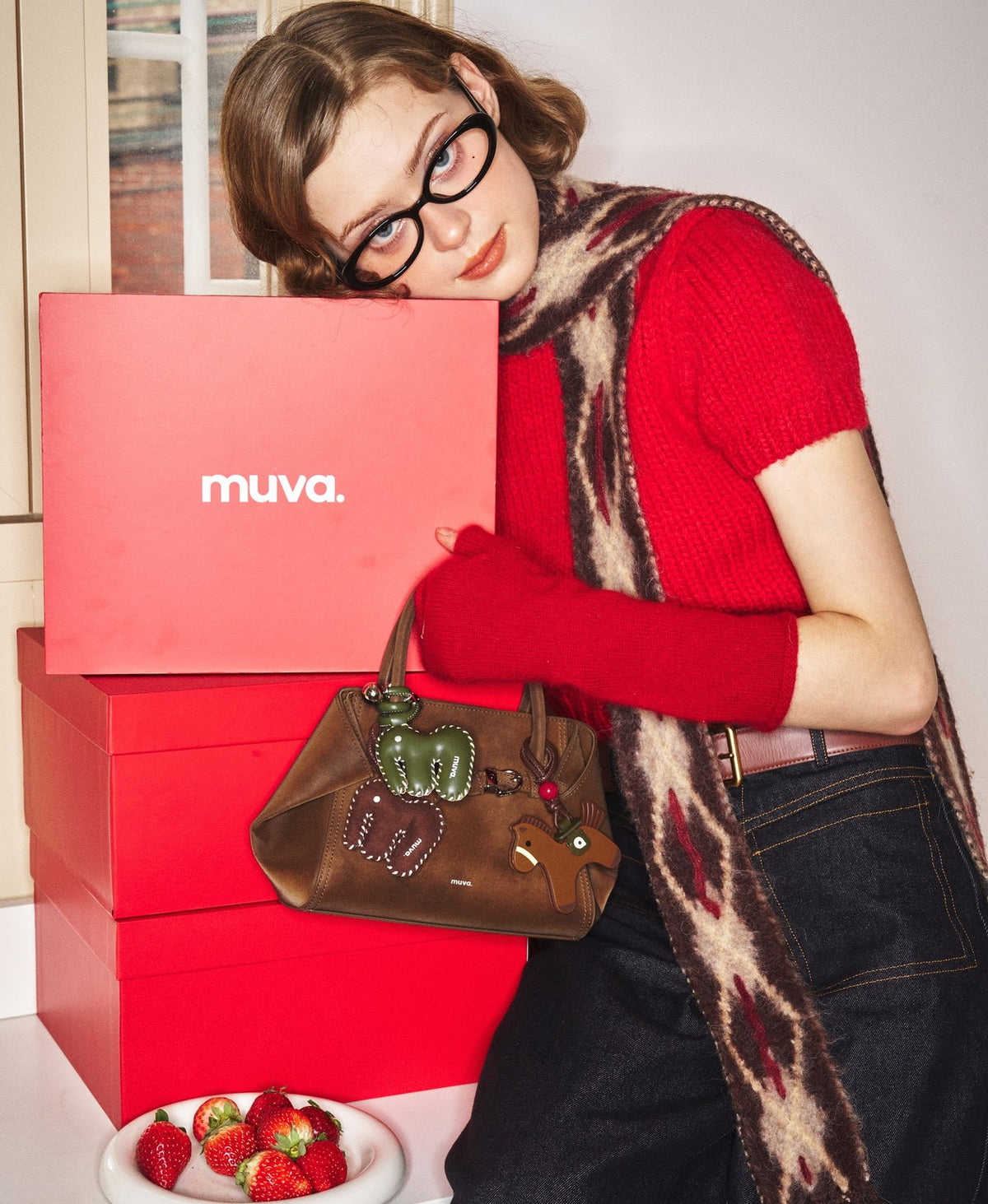 Model carrying the Tab Strap Fold-Over Handbag · Microsuede in Latte Brown