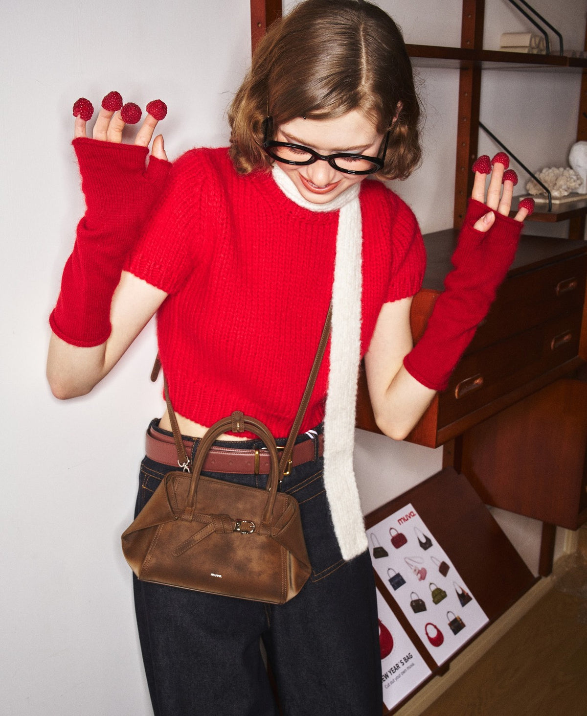 Model carrying the Tab Strap Fold-Over Handbag · Microsuede in Latte Brown