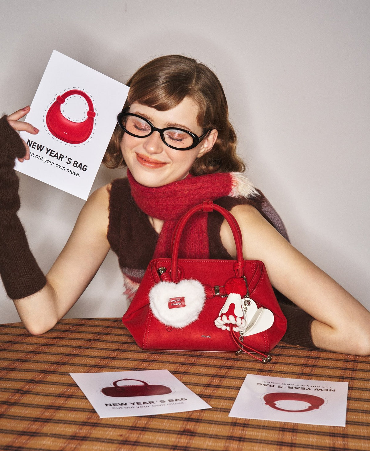 Model carrying the Tab Strap Fold-Over Handbag · Microsuede in Red