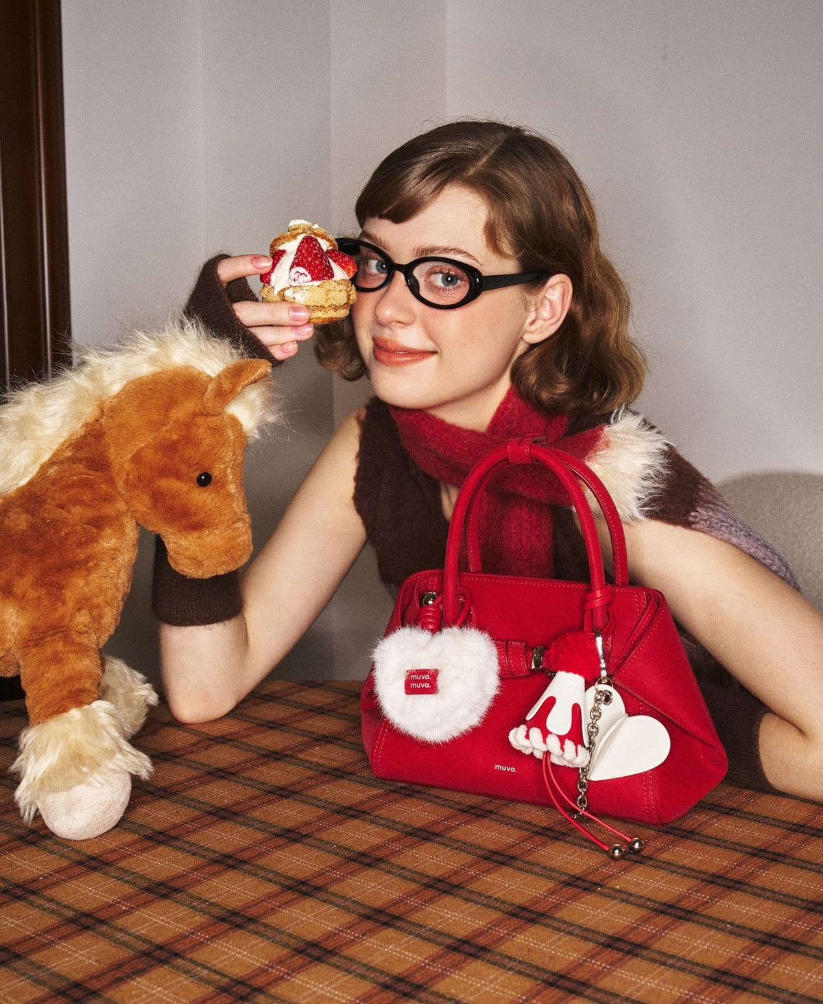 Model carrying the Tab Strap Fold-Over Handbag · Microsuede in Red