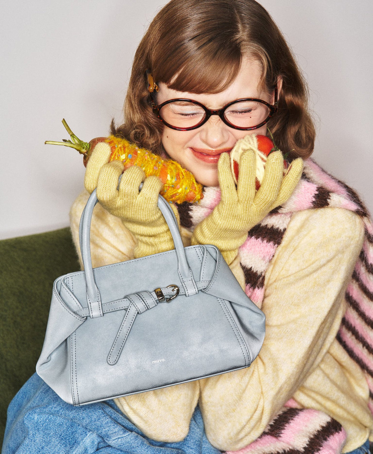 Model carrying the Tab Strap Fold-Over Handbag in Microsuede