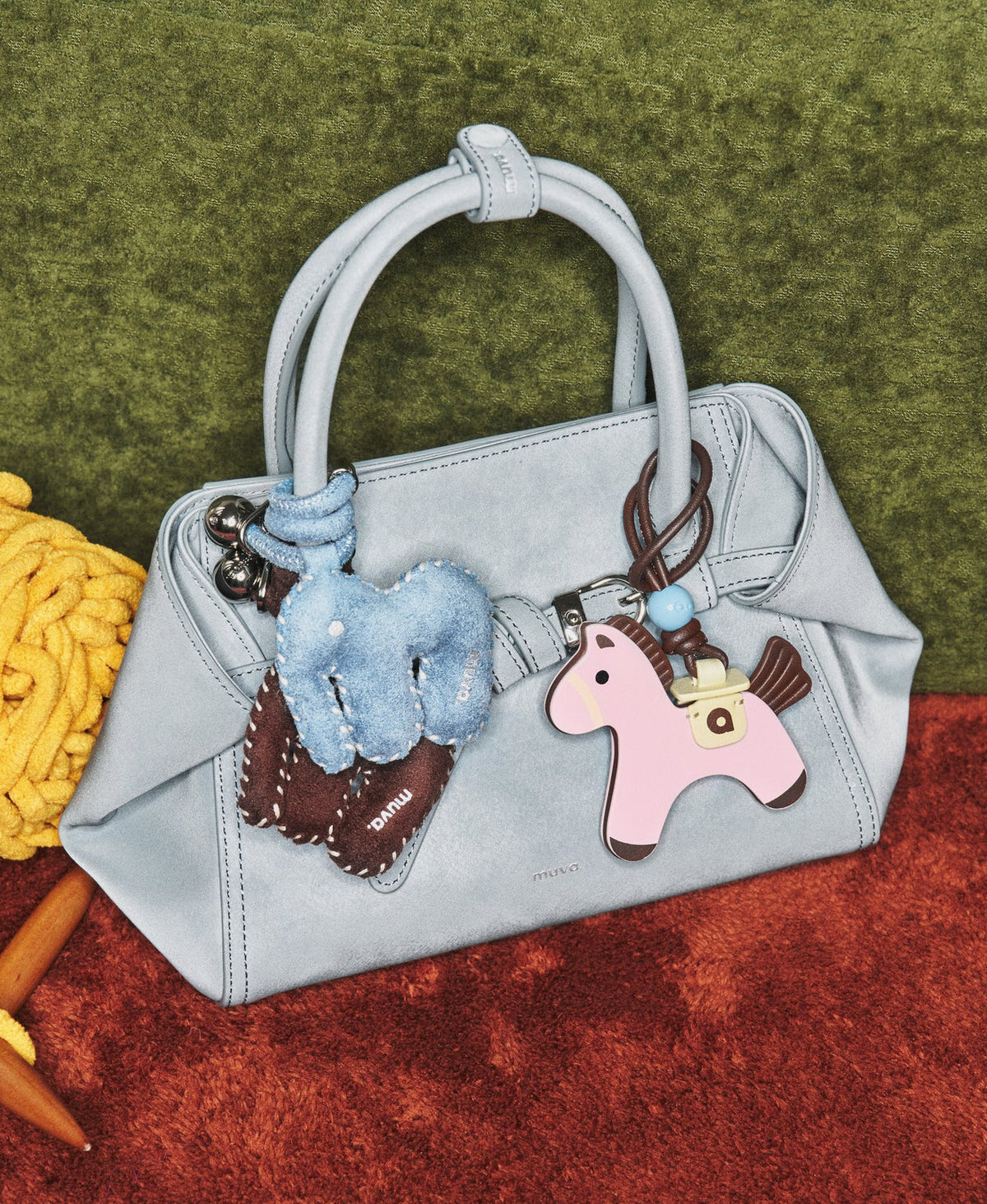 Model carrying the Tab Strap Fold-Over Handbag in Microsuede