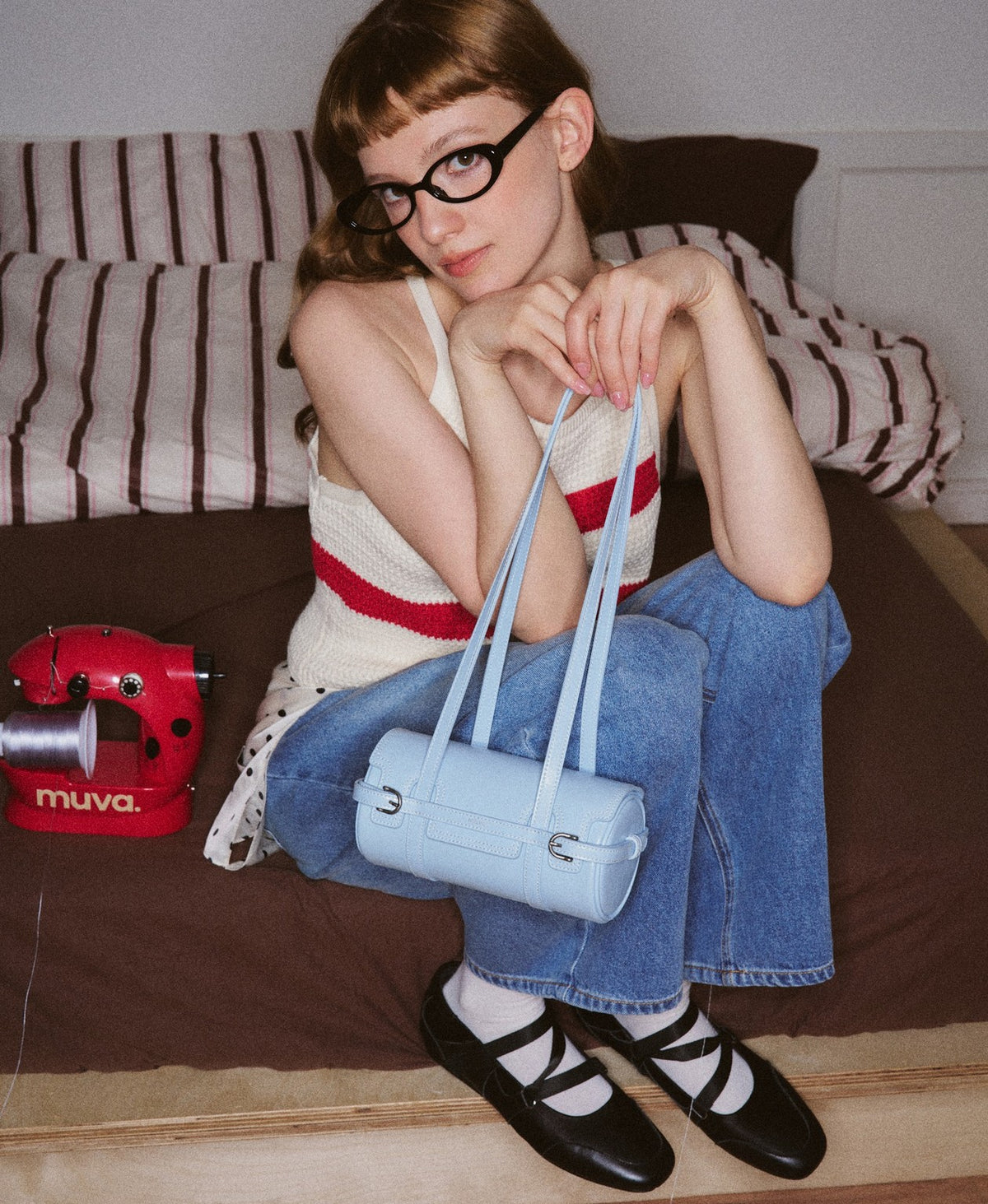 Model carrying the Hopscotch Tales Hopscotch Cylinder Bag in Sky Blue
