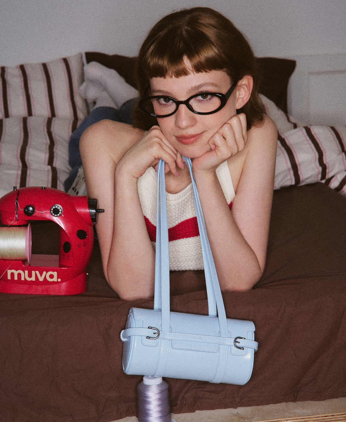 Model carrying the Hopscotch Tales Hopscotch Cylinder Bag in Sky Blue