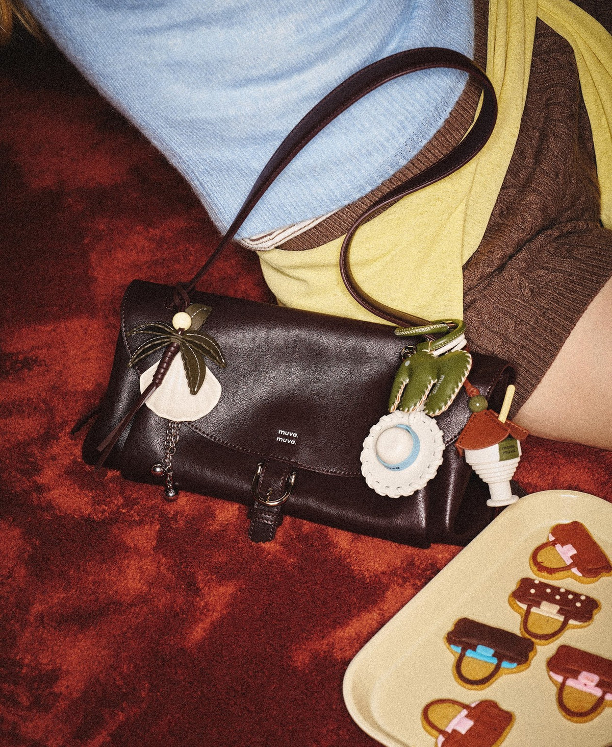 Model carrying the Paradise Pleat Bag in Chocolate Brown