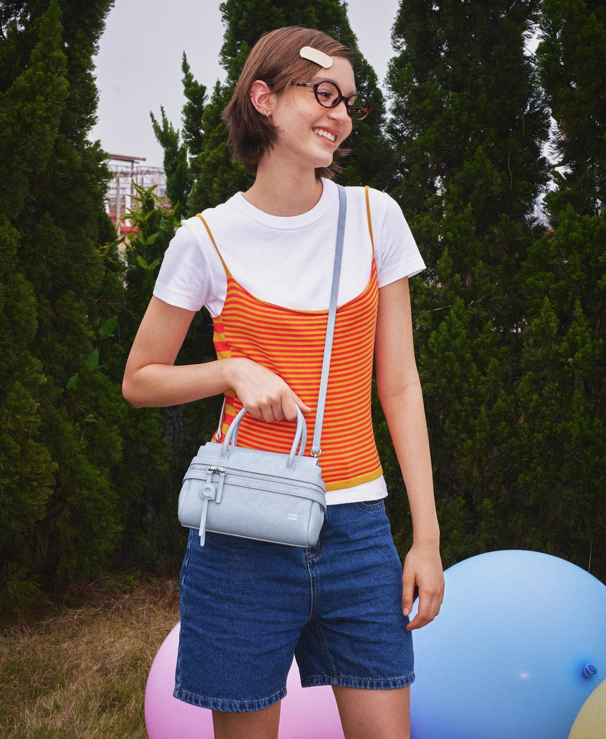 Model carrying the BoBo Lala Soda Bag in Sky Blue