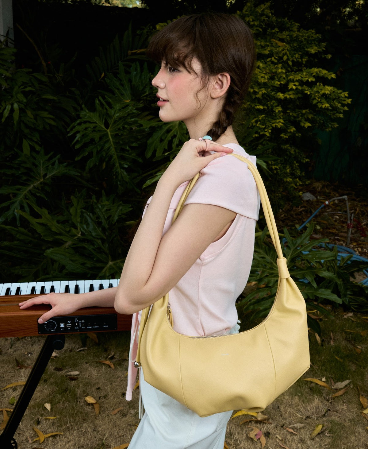 Model carrying the Jingle Croissant Bag in Creamy Yellow