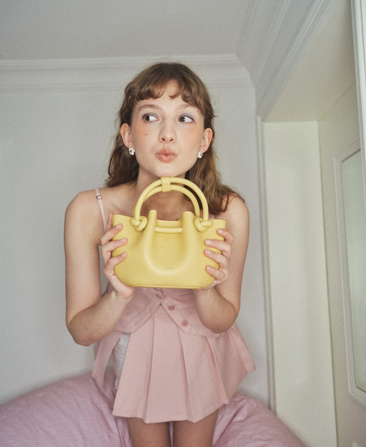 Model carrying the Flower Bud Bag in Creamy Yellow