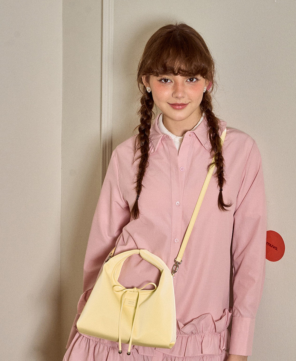Roly-Poly Triangle Onigiri Bag in Creamy Yellow worn crossbody