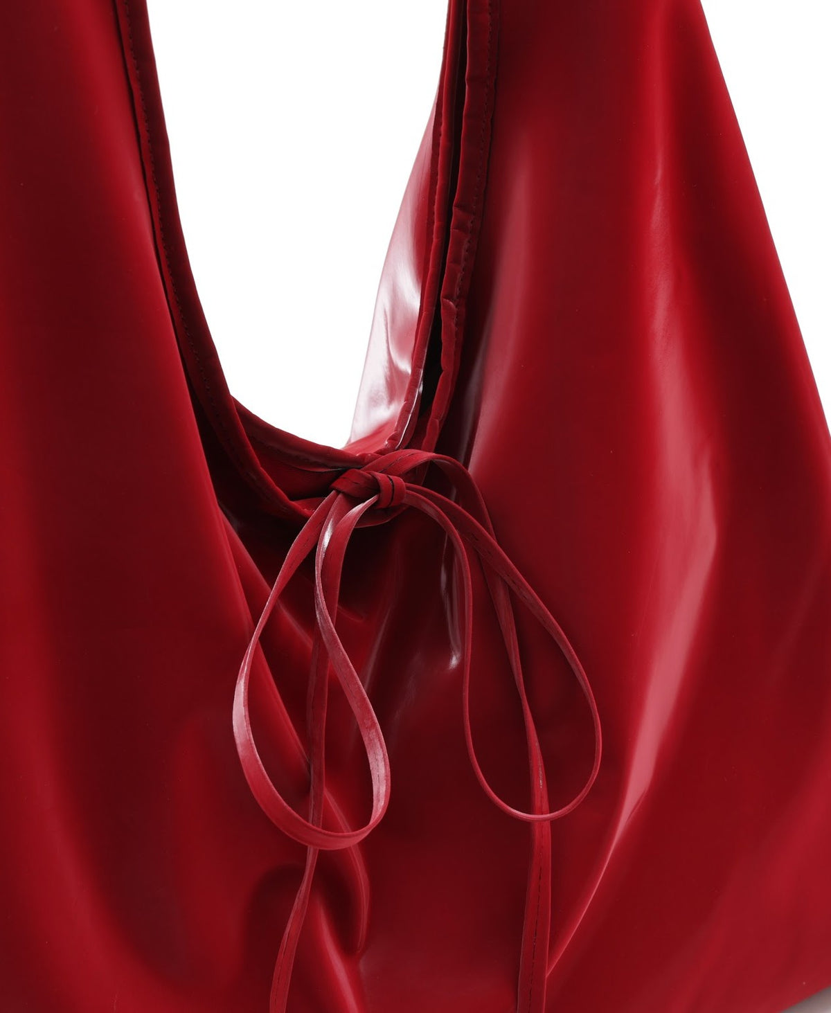 Model carrying the Roly-Poly Pleat Tote in Red