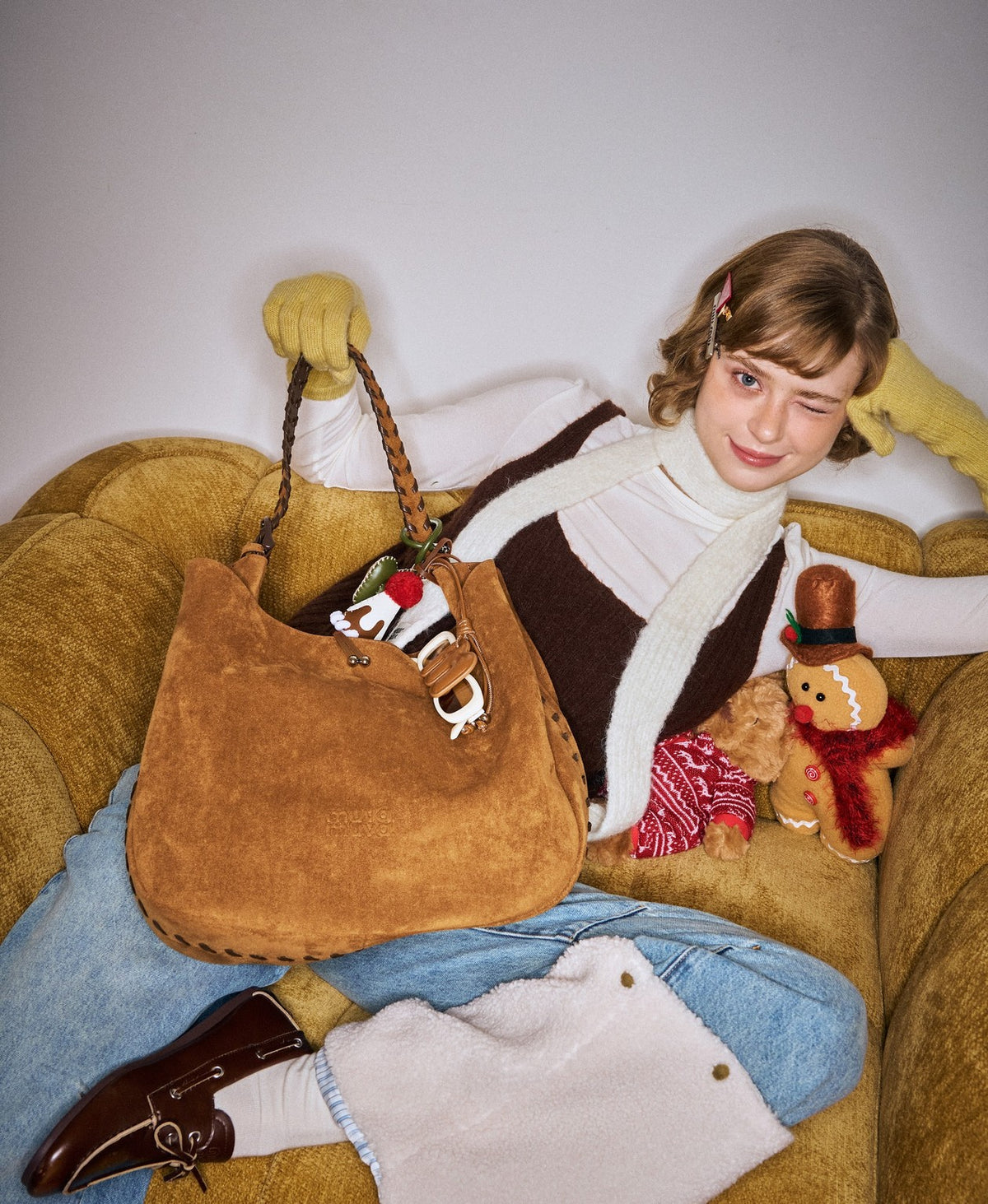 Model carrying the Lace-Up Hobo Bag in Caramel Brown