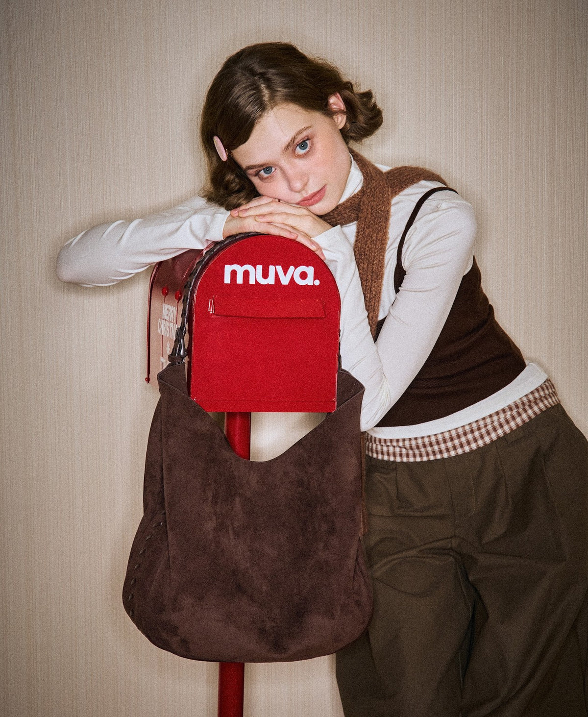 Model carrying the Lace-Up Hobo Bag in Chocolate Brown