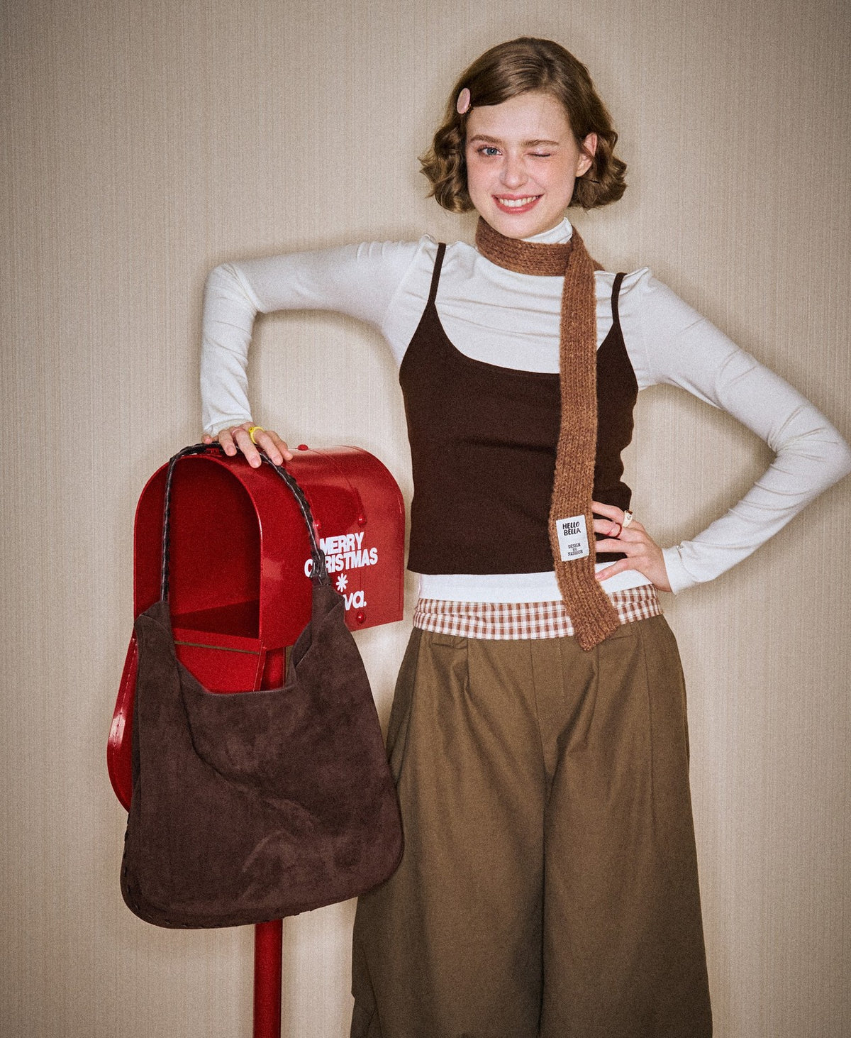 Model carrying the Companion Lace-Up Hobo Bag in Chocolate Brown
