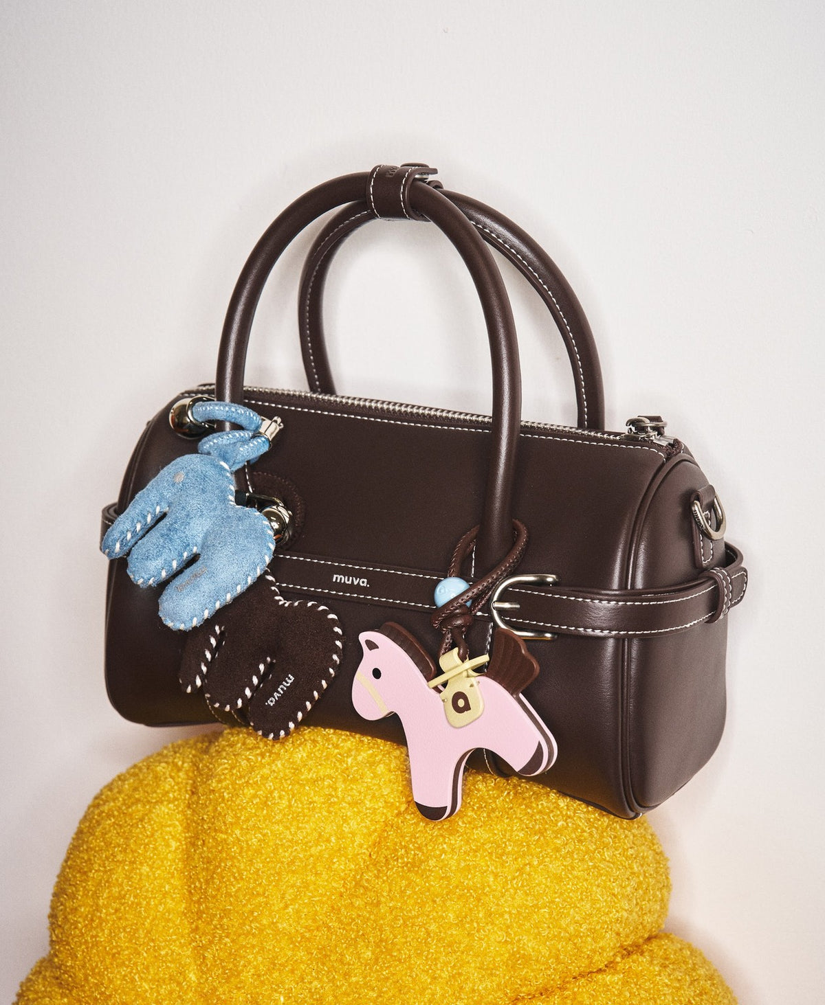 Model carrying the Hopscotch Tales Pillow Bag in Chocolate Brown