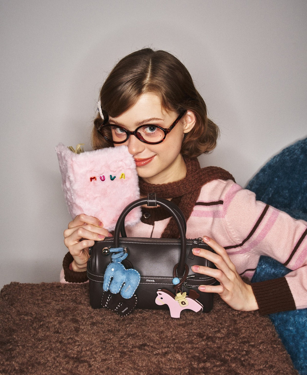 Model carrying the Hopscotch Tales Pillow Bag in Chocolate Brown