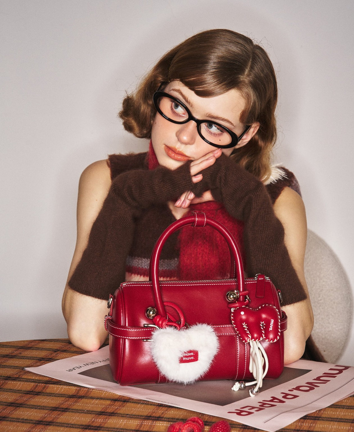 Model carrying the Hopscotch Tales Pillow Bag in Red